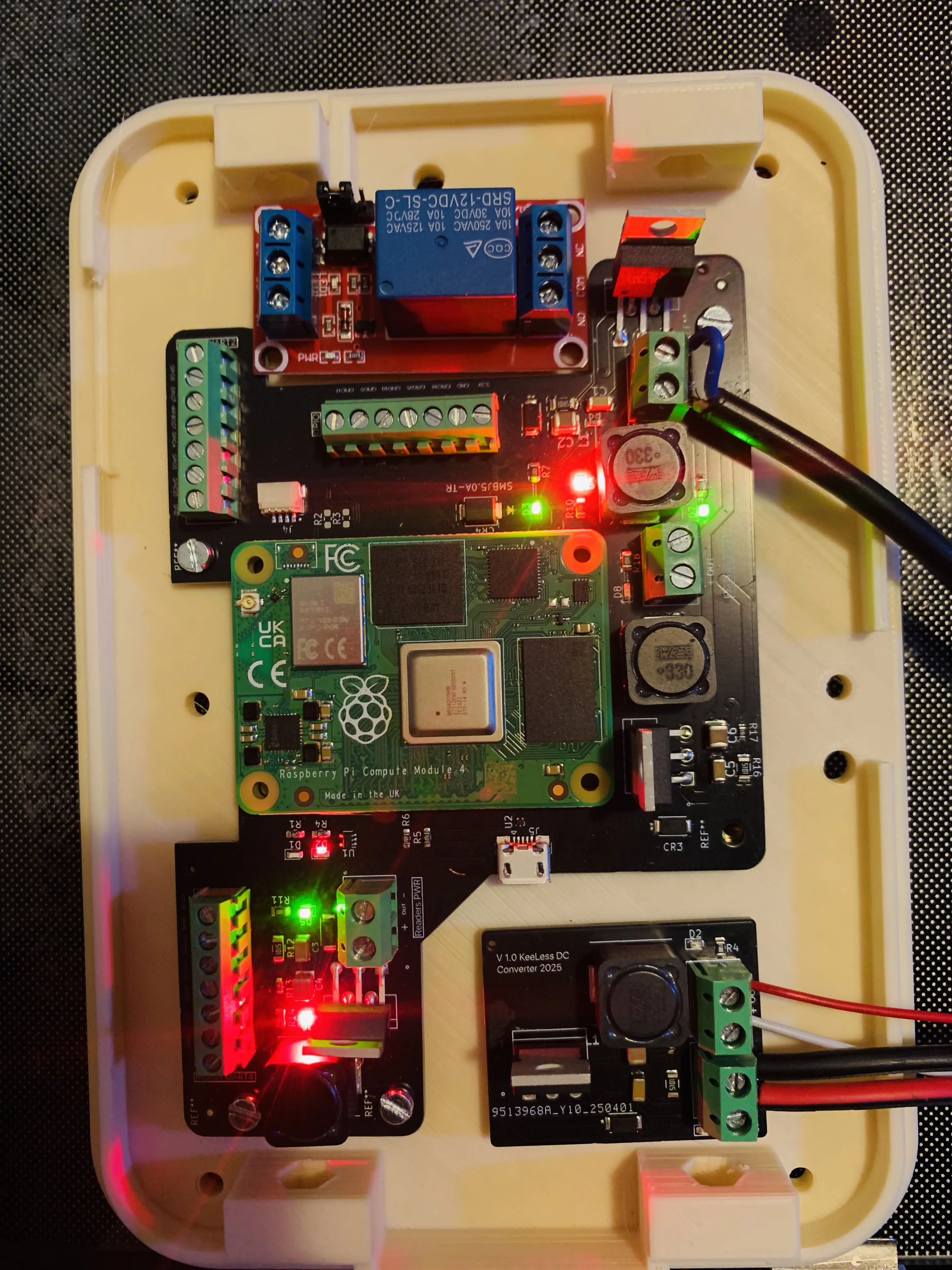 Assembled KeeLess controller board open, showing Compute Module and relay boards